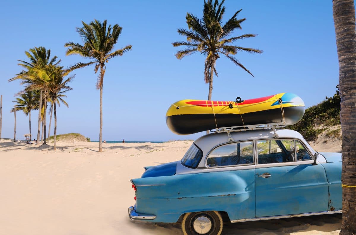 Collage of Cuban landscapes, classic cars, and culture